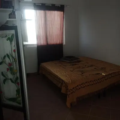a bedroom with a bed and a window at Ca Azul in Tarrafal