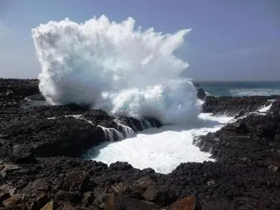 a cloud of steam is coming out of a waterfall at Studio Murdeira Side Beach, Eco Protected Bay, Pool in Beirona