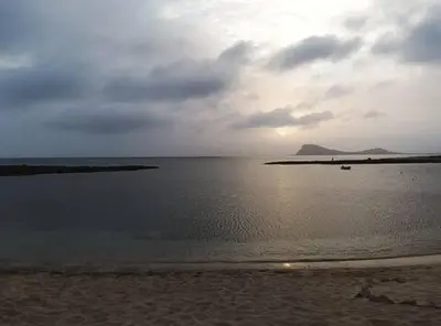 a view of a beach with a cloudy sky and the ocean at Studio Murdeira Side Beach, Eco Protected Bay, Pool in Beirona