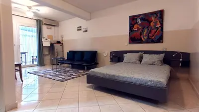 a bedroom with a bed and a chair in it at Studio Murdeira Side Beach, Eco Protected Bay, Pool in Beirona