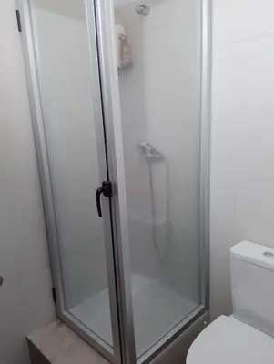a shower with a glass door in a bathroom at ApartamentoT1 Ponta do Sol in Ponta do Sol