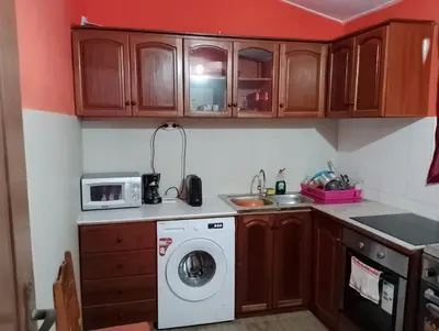 a kitchen with a washing machine and a microwave at ApartamentoT1 Ponta do Sol in Ponta do Sol