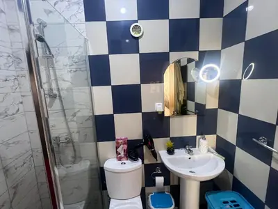 a bathroom with a toilet and a sink and a shower at Cozy kriol stay, steps to ocean in Praia
