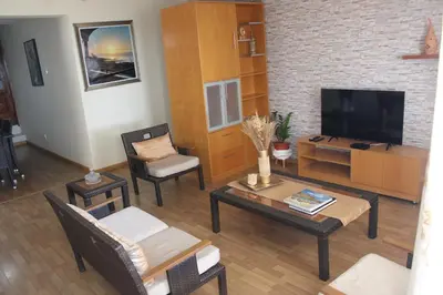 a living room with a television and a table and chairs at brISA in Praia