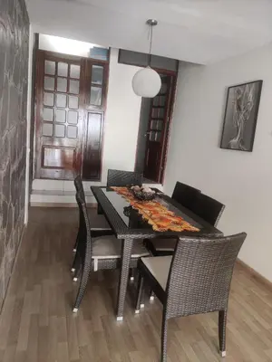 a dining room with a table and chairs at brISA in Praia