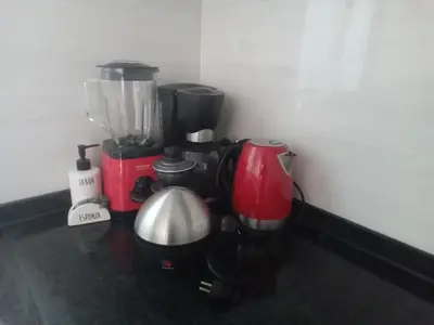 a kitchen counter with a blender and other appliances at Relache House Praia in Praia