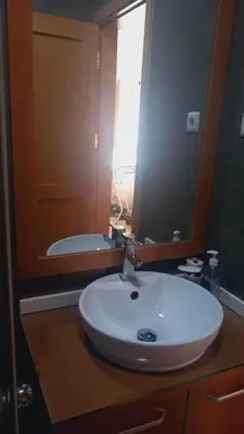 a bathroom with a white sink and a mirror at Relache House Praia in Praia