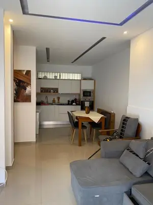 a living room with a couch and a table at Infinito house in Praia