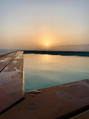 a body of water with the sunset in the background at Cacimba Sunset Lodge in Tarrafal