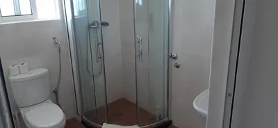 a bathroom with a toilet and a glass shower at Cacimba Sunset Lodge in Tarrafal