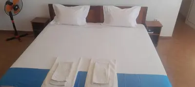 a large white bed with two pillows on it at Cacimba Sunset Lodge in Tarrafal
