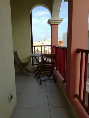 a balcony with a table and chairs and a window at Casa Sara Boavista in Sal Rei