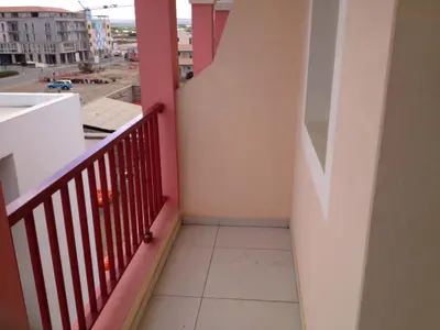 a balcony with a red railing and a view of a street at Casa Sara Boavista in Sal Rei