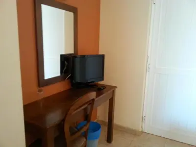 a television sitting on a desk with a mirror at Quinta Da Montanha in Rui Vaz