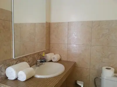 a bathroom with a sink and a mirror and towels at Quinta Da Montanha in Rui Vaz