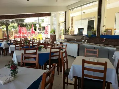 a restaurant with tables and chairs and a kitchen at Quinta Da Montanha in Rui Vaz