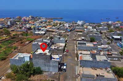 an aerial view of a city with houses and the ocean at Casa Magui de Reis in Tarrafal