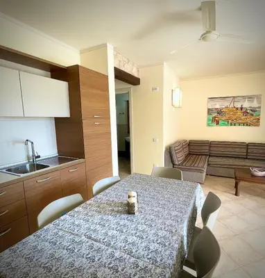 a kitchen and dining room with a table and a couch at Ocean & Pool - 2 bedroom Apartment in Santa Maria