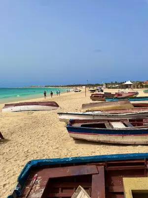 a group of boats sitting on a beach at Ocean & Pool - 2 bedroom Apartment in Santa Maria