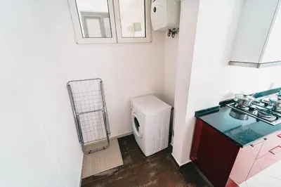 a small bathroom with a toilet and a sink at T2 amplo com ar condicionado e perto da praia in Praia