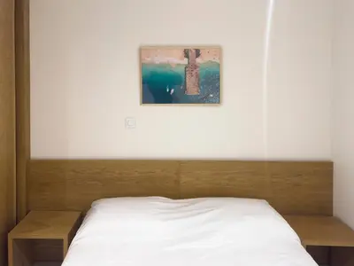 a bed in a bedroom with a picture on the wall at 1 bdr charming central apt in Praça Center - LCGR in Praia