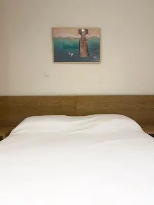 a bedroom with a white bed with a picture on the wall at 1 bdr charming central apt in Praça Center - LCGR in Praia