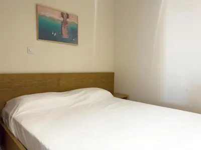 a white bed in a room with a picture on the wall at 1 bdr charming central apt in Praça Center - LCGR in Praia