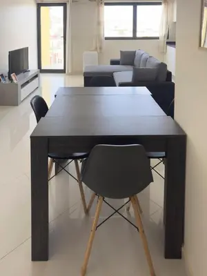 a dining room table and chairs in a living room at 1 bdr charming central apt in Praça Center - LCGR in Praia