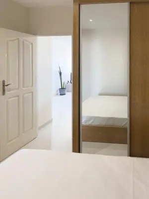 a bedroom with a mirror next to a bed at 1 bdr charming central apt in Praça Center - LCGR in Praia