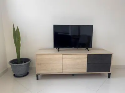 a tv sitting on top of a wooden dresser at 1 bdr cozy central apt in Praça Center - LCGR in Praia