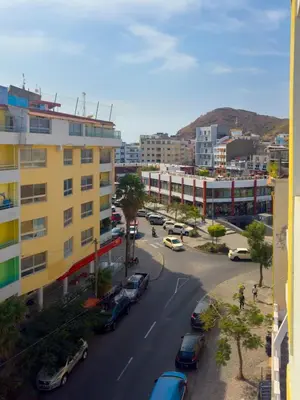 a view of a city with cars parked on a street at 1 bdr cozy central apt in Praça Center - LCGR in Praia