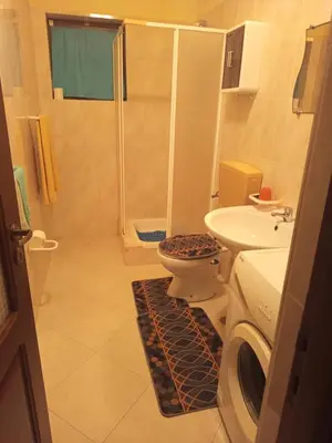 a bathroom with a shower and a toilet and a sink at Appartamento Gianni in Santa Maria