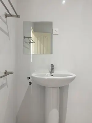 a white bathroom with a sink and a mirror at 2 bdr charming central apt in Praça Center - LCGR in Praia