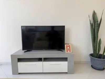 a flat screen tv sitting on top of a white entertainment center at 2 bdr charming central apt in Praça Center - LCGR in Praia
