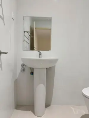 a white bathroom with a sink and a mirror at 2 bdr charming central apt in Praça Center - LCGR in Praia