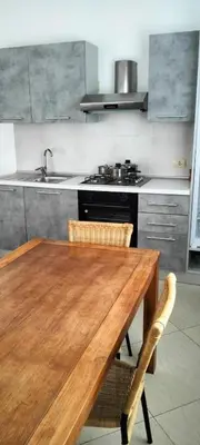 a kitchen with a wooden table and a stove at Girasole Apartments in Sal Rei