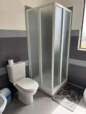 a bathroom with a toilet and a shower at Girasole Apartments in Sal Rei