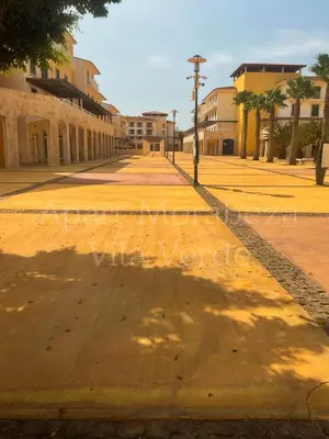 an empty street in a town with buildings at Morabeza Vila Verde in Santa Maria