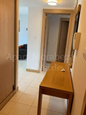 a room with a wooden table and a living room at Morabeza Vila Verde in Santa Maria