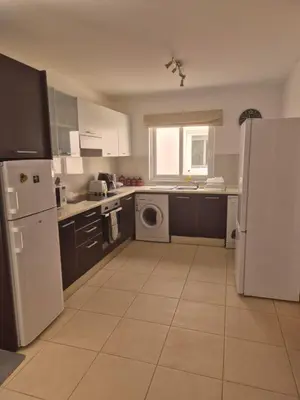 a kitchen with a white refrigerator and a dishwasher at 3 Bedroom property in Paradise Beach in Santa Maria