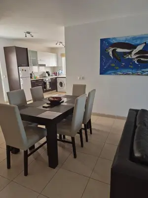 a dining room with a table and chairs at 3 Bedroom property in Paradise Beach in Santa Maria