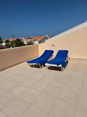 two blue chairs sitting on the roof of a building at 3 Bedroom property in Paradise Beach in Santa Maria