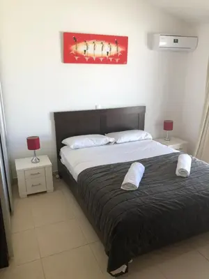 a bedroom with two beds and a painting on the wall at 3 Bedroom property in Paradise Beach in Santa Maria