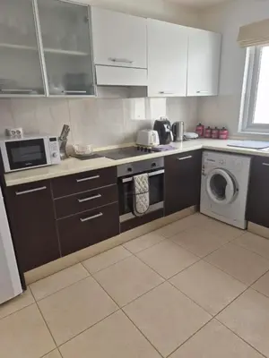 a kitchen with a stove and a washing machine at 3 Bedroom property in Paradise Beach in Santa Maria