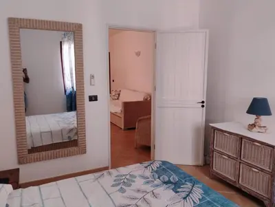 a bedroom with a bed and a large mirror at Greta Apartment in Santa Maria