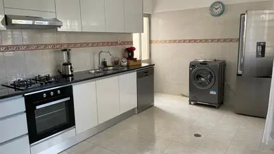 a kitchen with a stove and a washing machine at Appartement 3 chambres tout confort in Praia