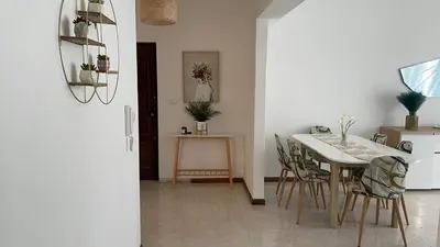 a kitchen and dining room with a table and chairs at Appartement 3 chambres tout confort in Praia