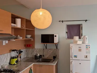a kitchen with a white refrigerator and a microwave at SeafrontView - Cozy T1 Apartment 1 in Praia