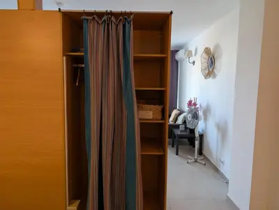 a closet with a curtain in a room at SeafrontView - Cozy T1 Apartment 1 in Praia