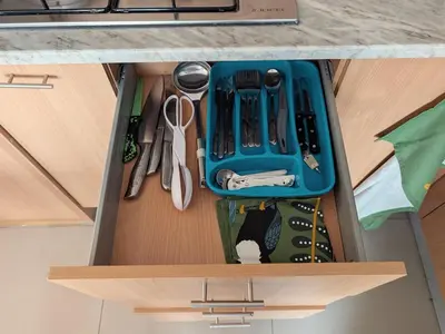 a drawer with a blue container and tools in it at SeafrontView - Cozy T1 Apartment 1 in Praia